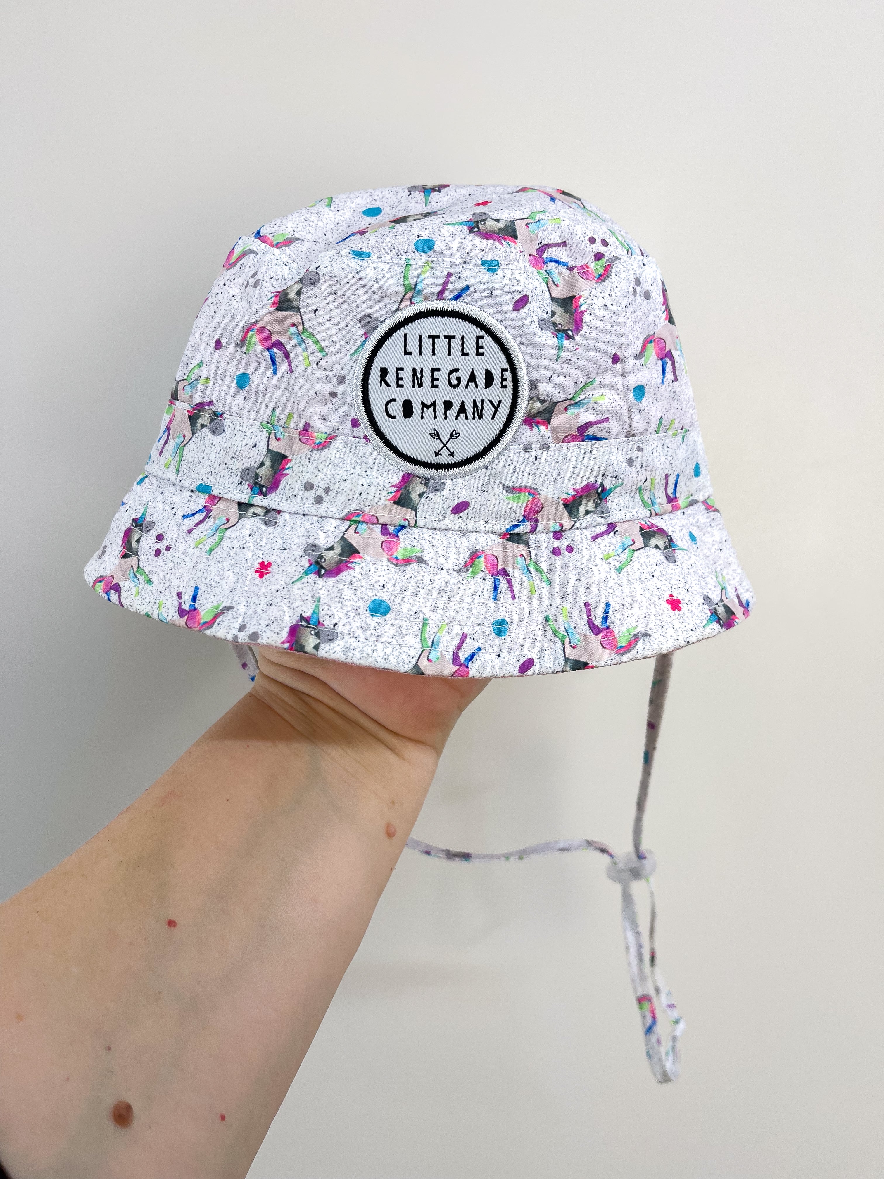 Little Renegade reversible hat - unicorns (0-1y)